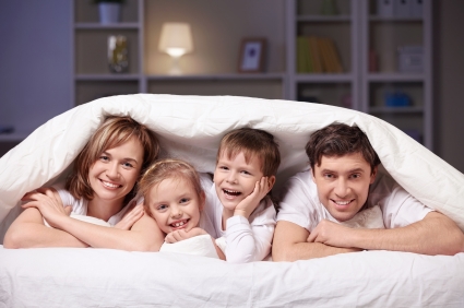 family under a blanket family under a blanket 6 Ways To Be Warm At Home Without Touching The Thermostat