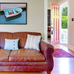 gray walls old couch open door thumb