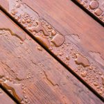 Pooled water on finished deck with woodgrain