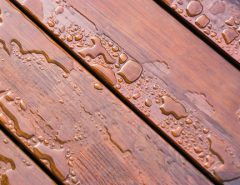 Pooled water on finished deck with woodgrain